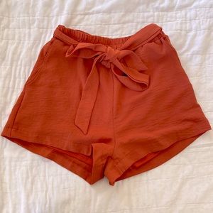 Orange bow tie flowy shorts